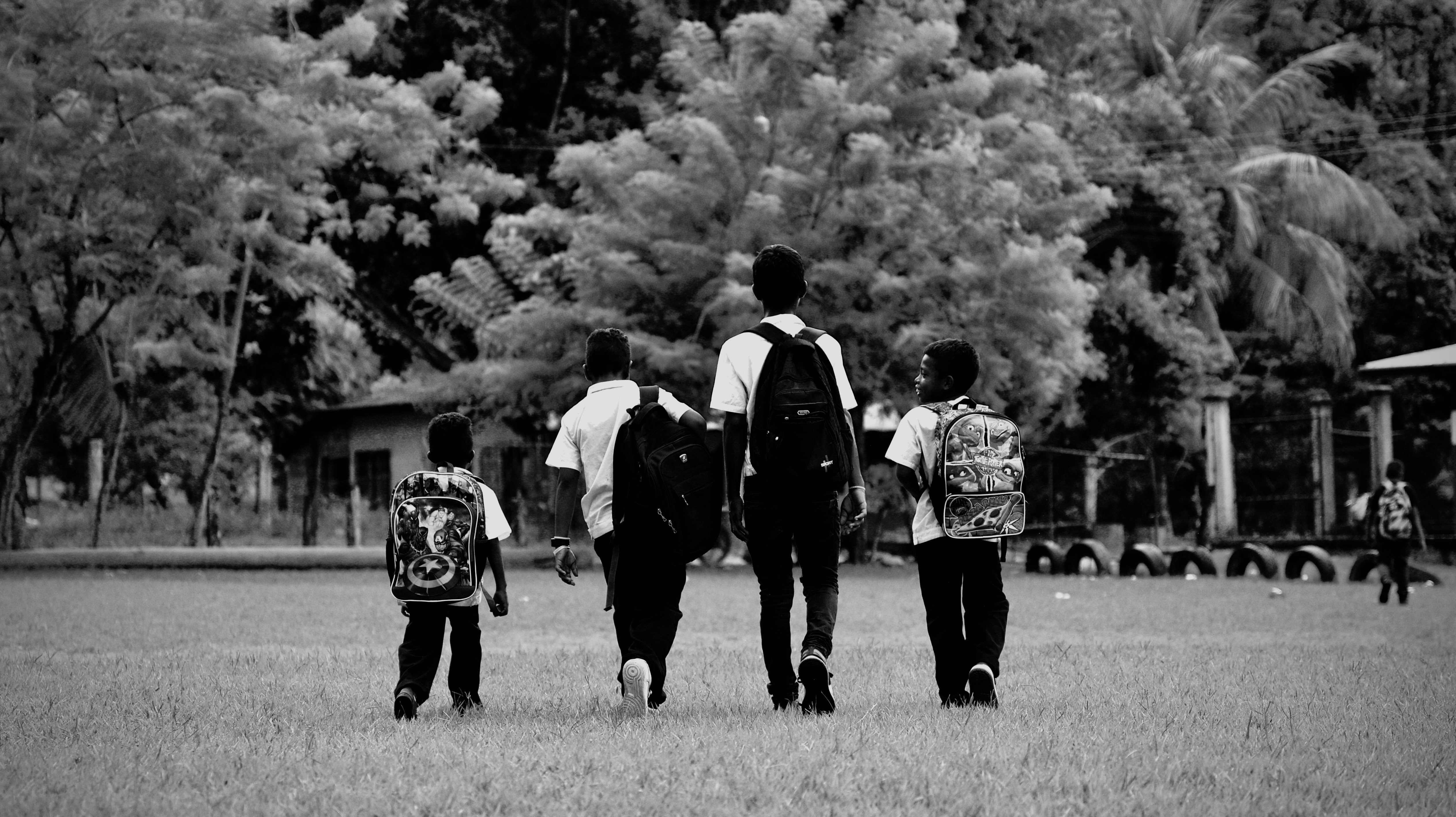 The kids walking away across the field