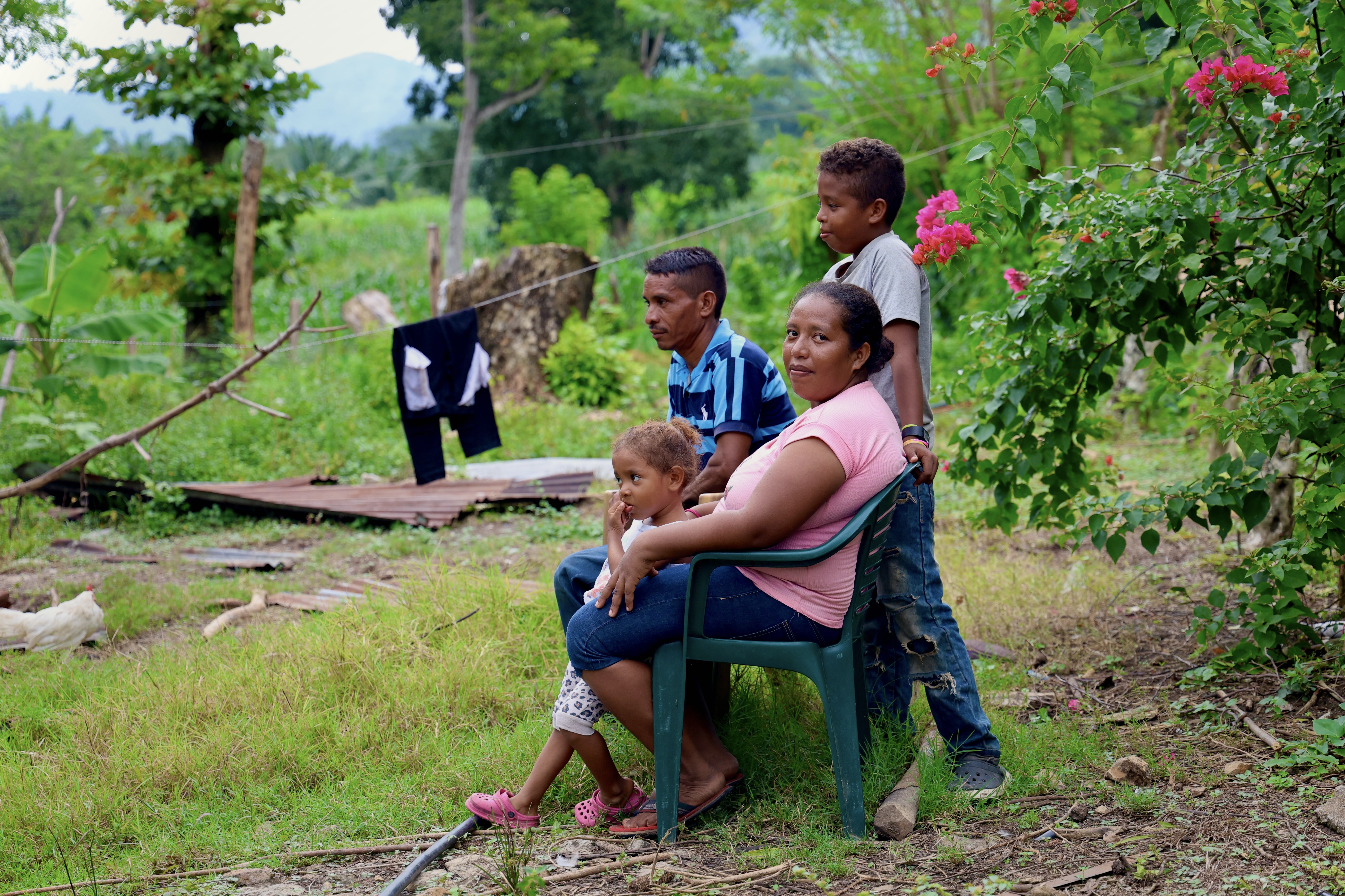 The family sitting together, looking into the distance