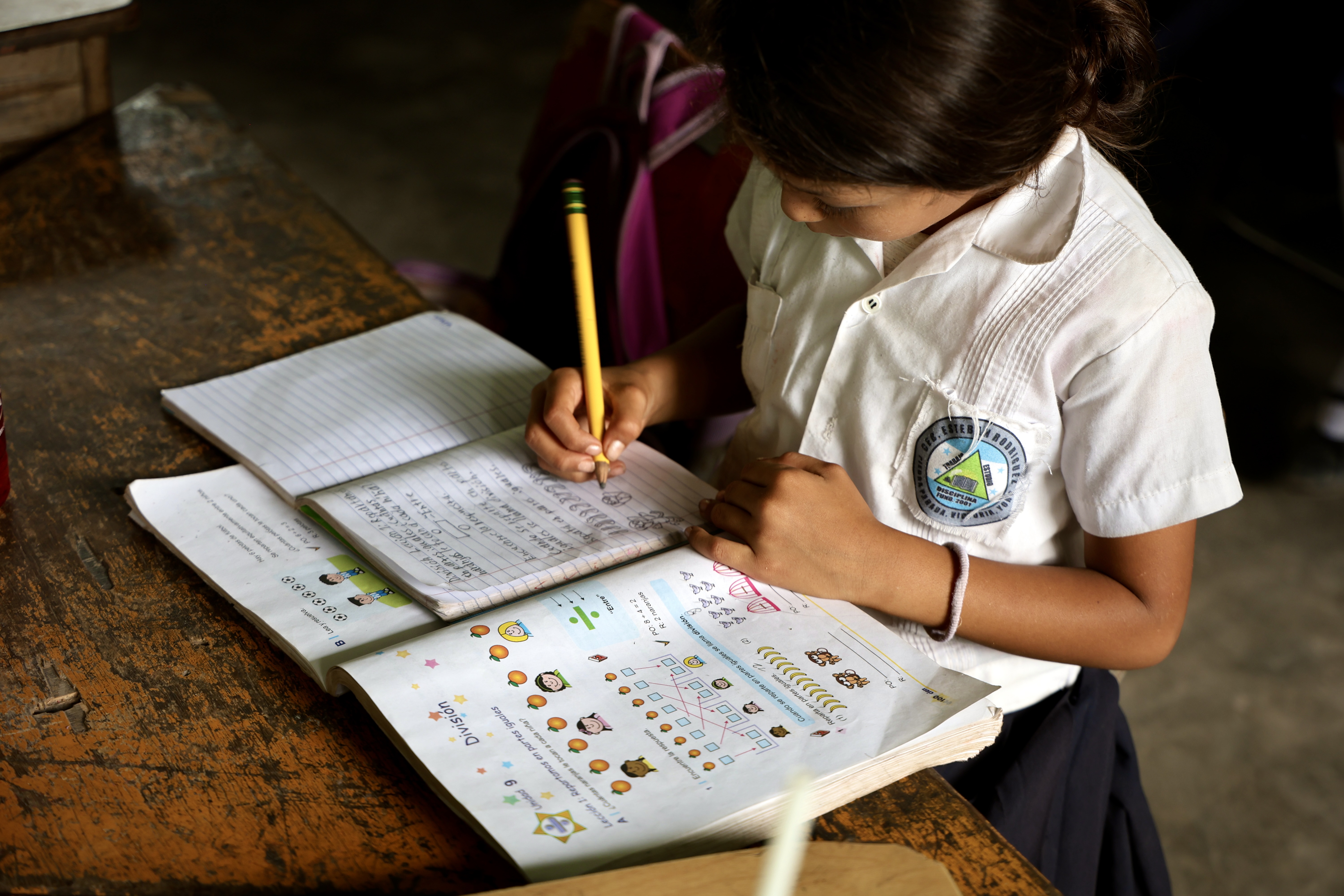 Girl writing in school notebook
