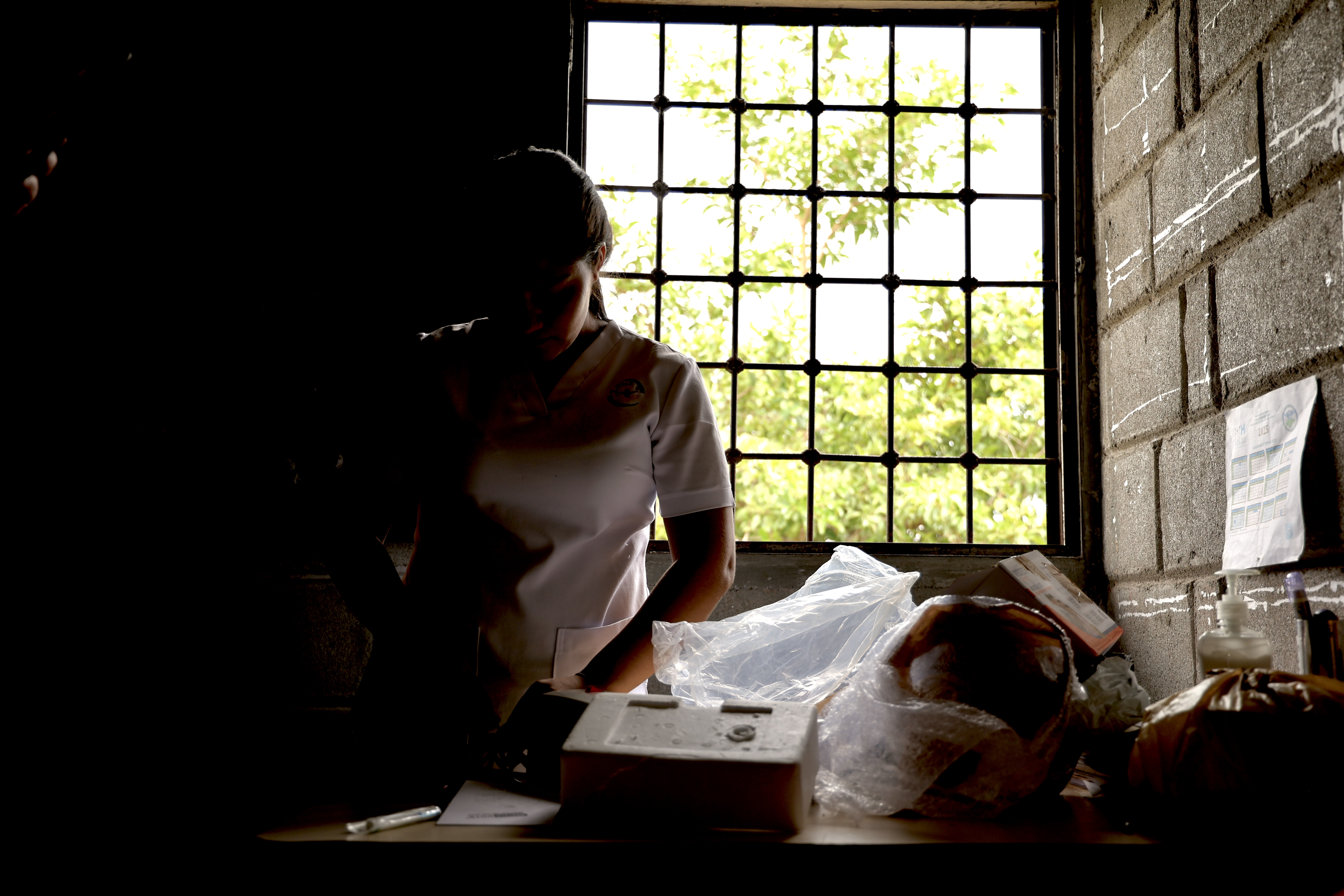 Student silhouetted by window